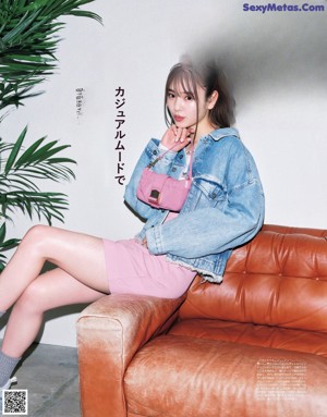 A magazine with a picture of a woman sitting on a chair.