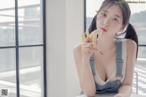 A woman wearing a black bra and a white shirt.