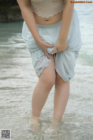 A woman in a black lingerie posing for the camera.