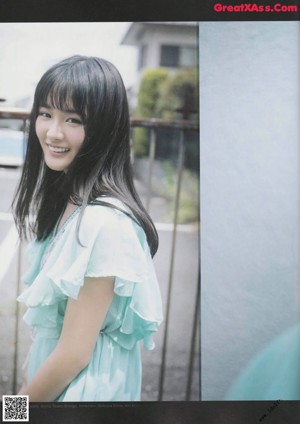 A woman in a white dress posing for a picture.