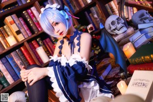 A woman in a blue and white dress holding a skull.