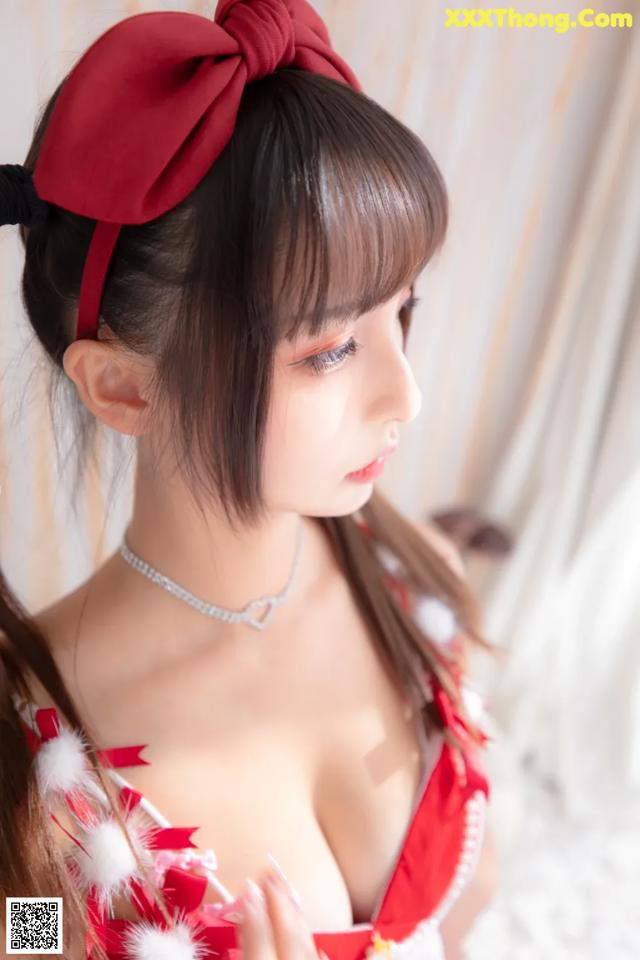 A woman in a red and white dress with a red bow.