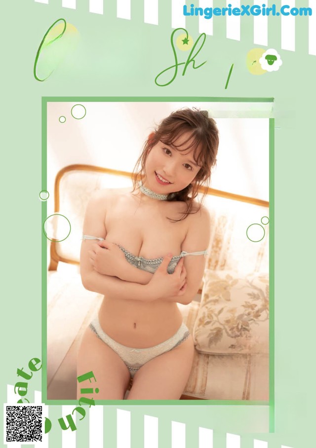 A woman in a white lingerie sitting on a bed.
