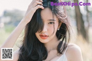 A woman with long black hair wearing a black shirt.