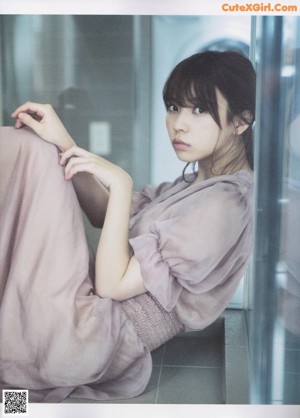 A woman in a pink shirt is posing for a picture.
