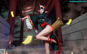 A woman in a green and red outfit is posing for a picture.