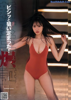 A woman in a red bikini posing for a picture.