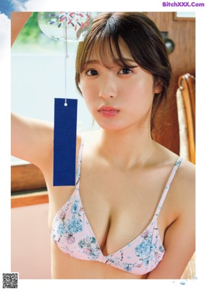 A woman in a bikini standing in front of a door.