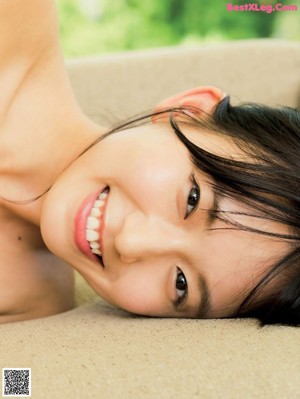 a japanese woman in a white bra top is posing for the camera